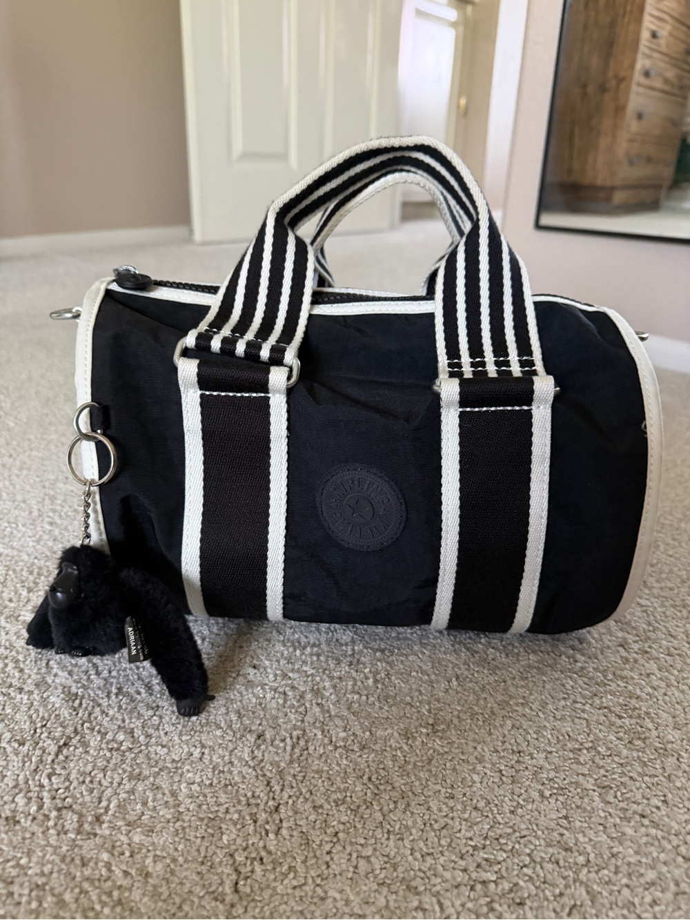 Kipling Black Barrel Bag with White Striped Handles